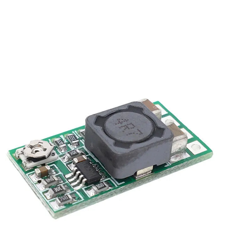 Green PCB mini DC-DC step down power supply module converting 12-24V to 5V 3A.