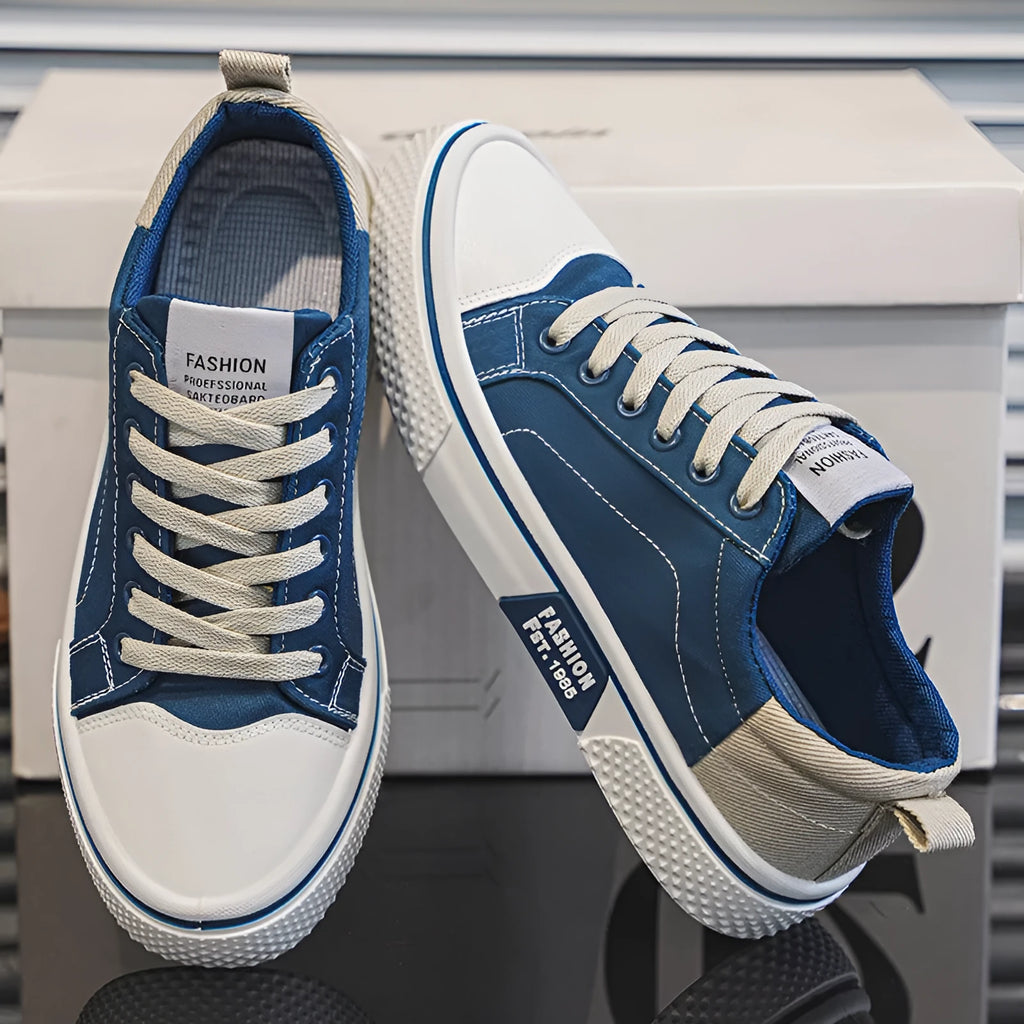 Men's blue low-top canvas casual sneakers with round toe and lace-up front on a white background.
