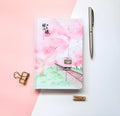 Muco hardcover notebook with Sakura Flower Orbit AR design in pink, green, red, or yellow.