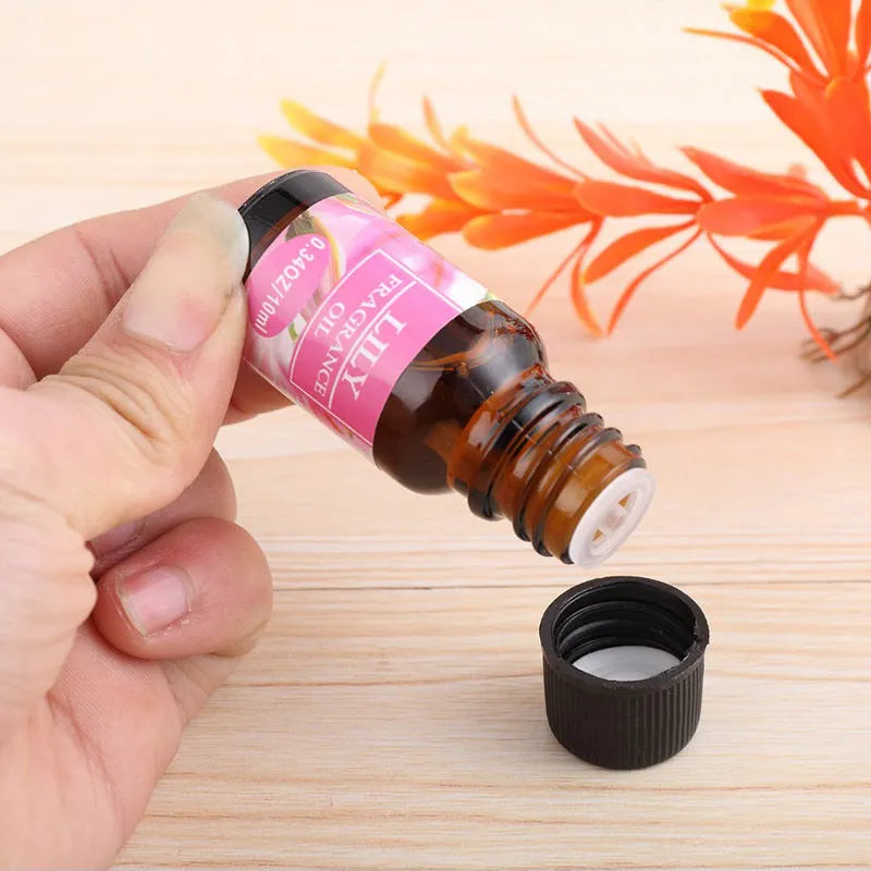 Set of 12 small glass bottles of aromatherapy essential oil, 10ml each, with labels showing Lavender, Rose, Lemon, and other fragrances.