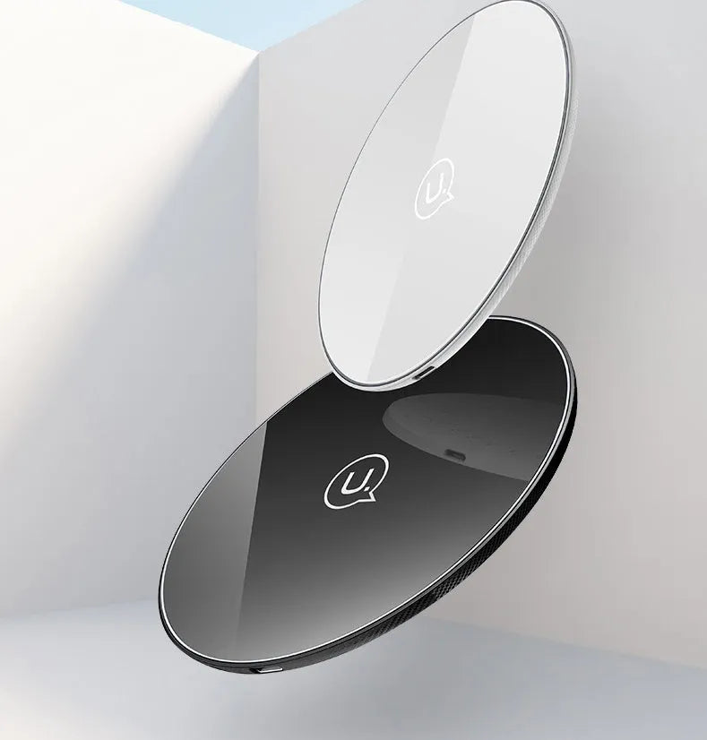 Black glass disc wireless charger with LED indicator light on smooth surface