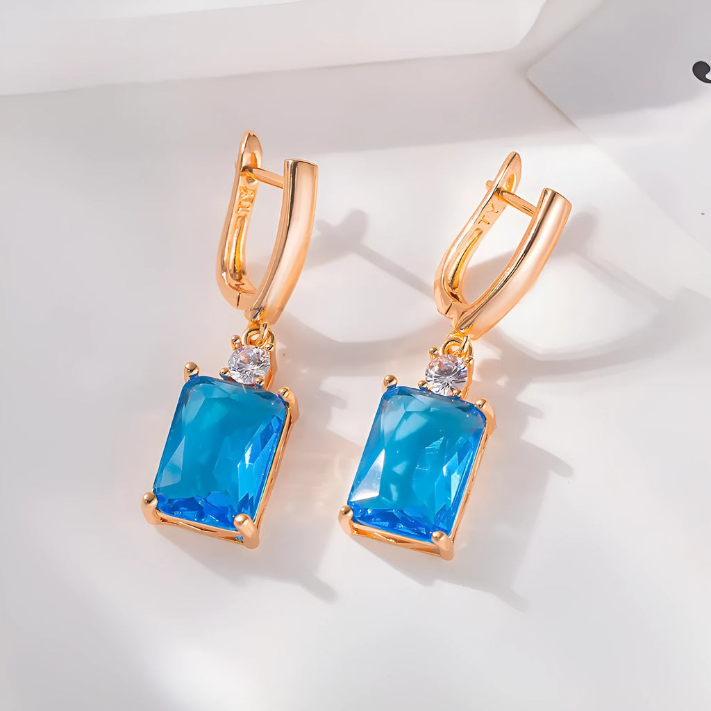 A pair of square geometric earrings in gold or silver colour, made from electroplated copper.