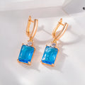 A pair of square geometric earrings in gold or silver colour, made from electroplated copper.