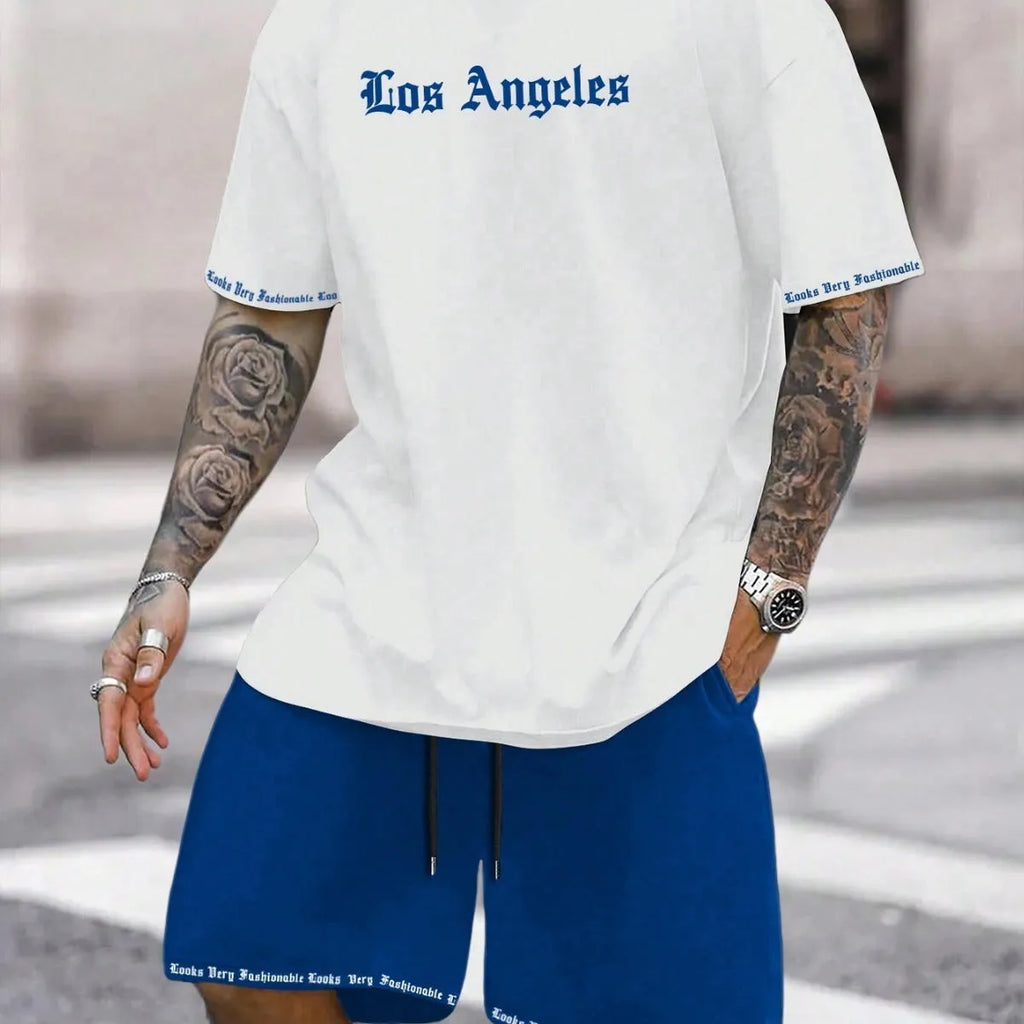Man wearing a blue short-sleeved top and matching shorts from a sports style suit set.