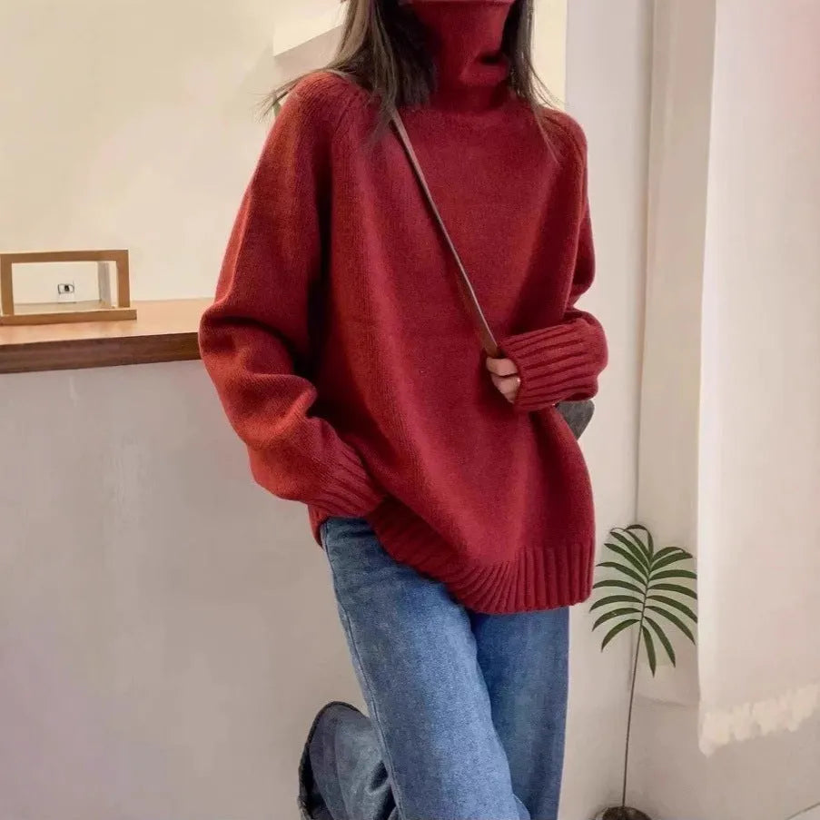 Women's loose fit turtleneck sweater with a thick, textured curling pile collar in a solid colour.