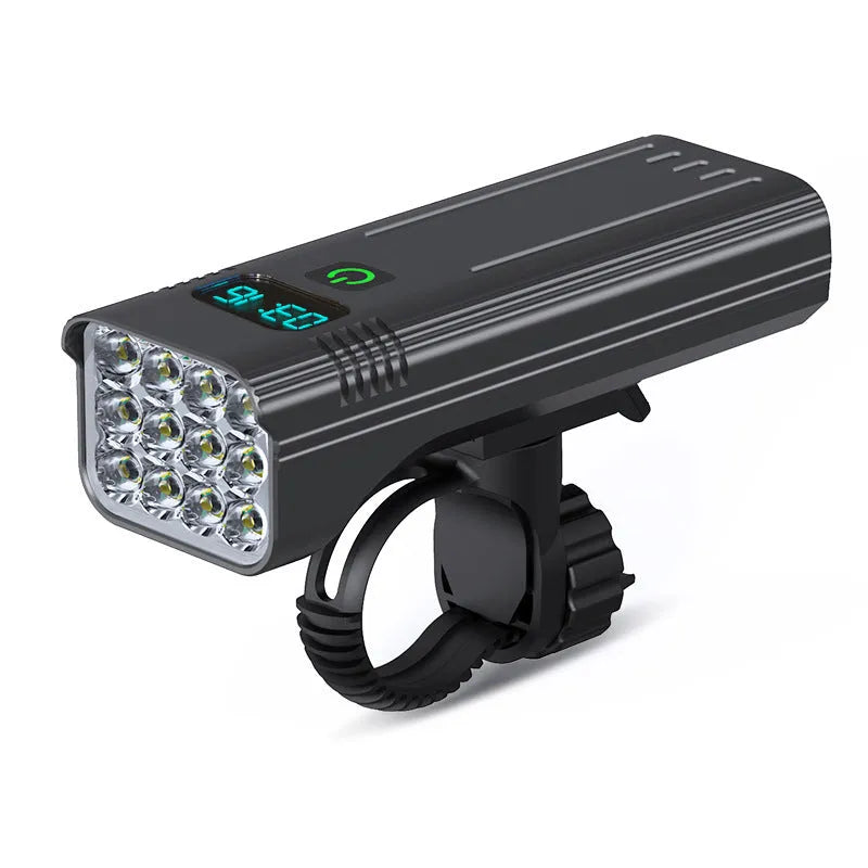 Black KX12DF digital display bicycle headlight with aluminium body mounted on bike handlebars via quick-release bracket.