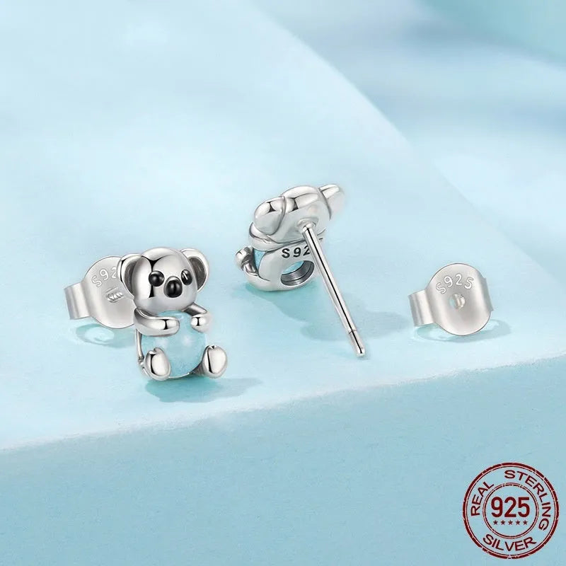 S925 sterling silver dangling koala bear earrings with dripping oil finish on a white background