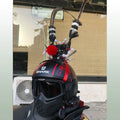 Black crown and long feather decoration for customising a motorcycle helmet.