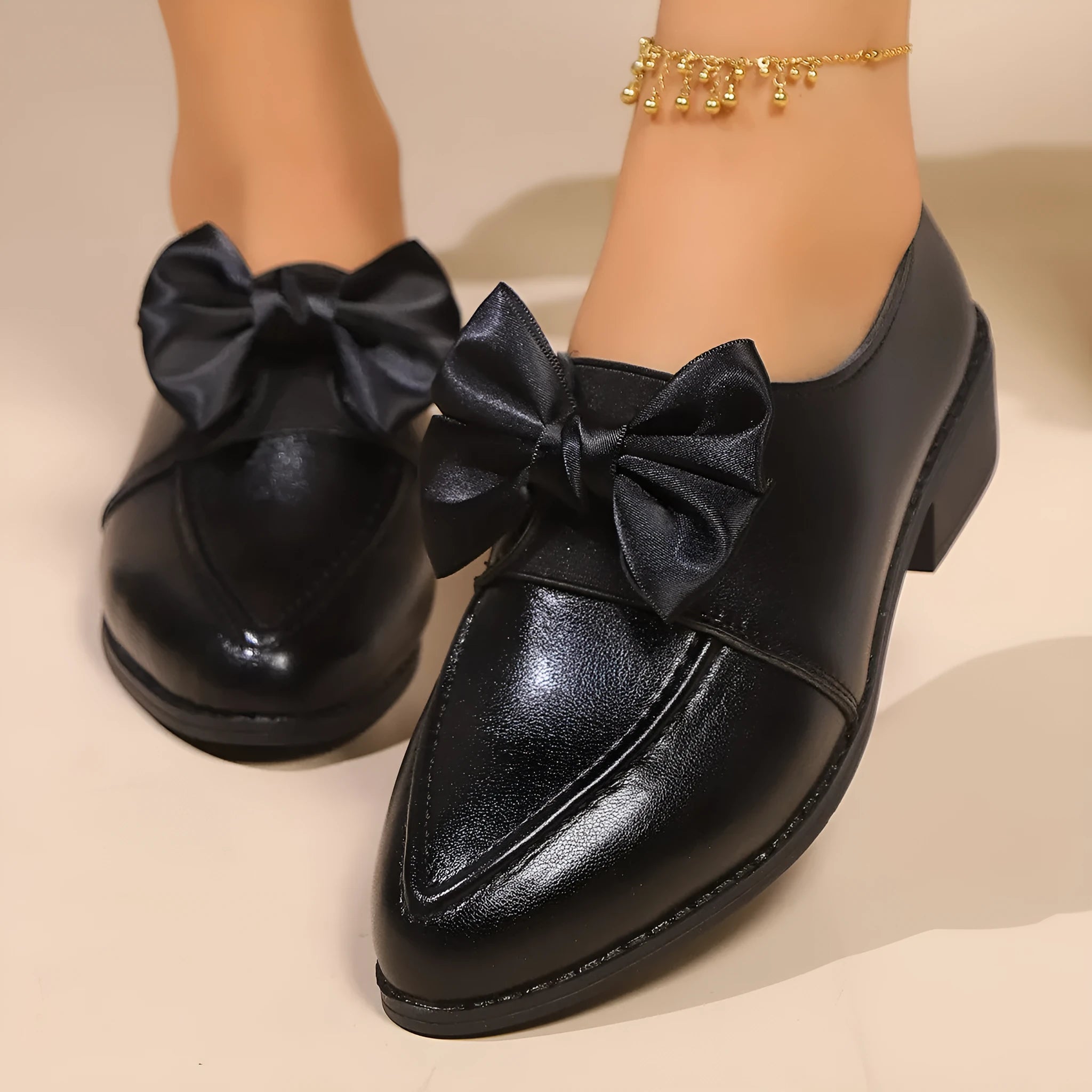 Women's British-style loafers with a bow detail on a PU upper and rubber sole.