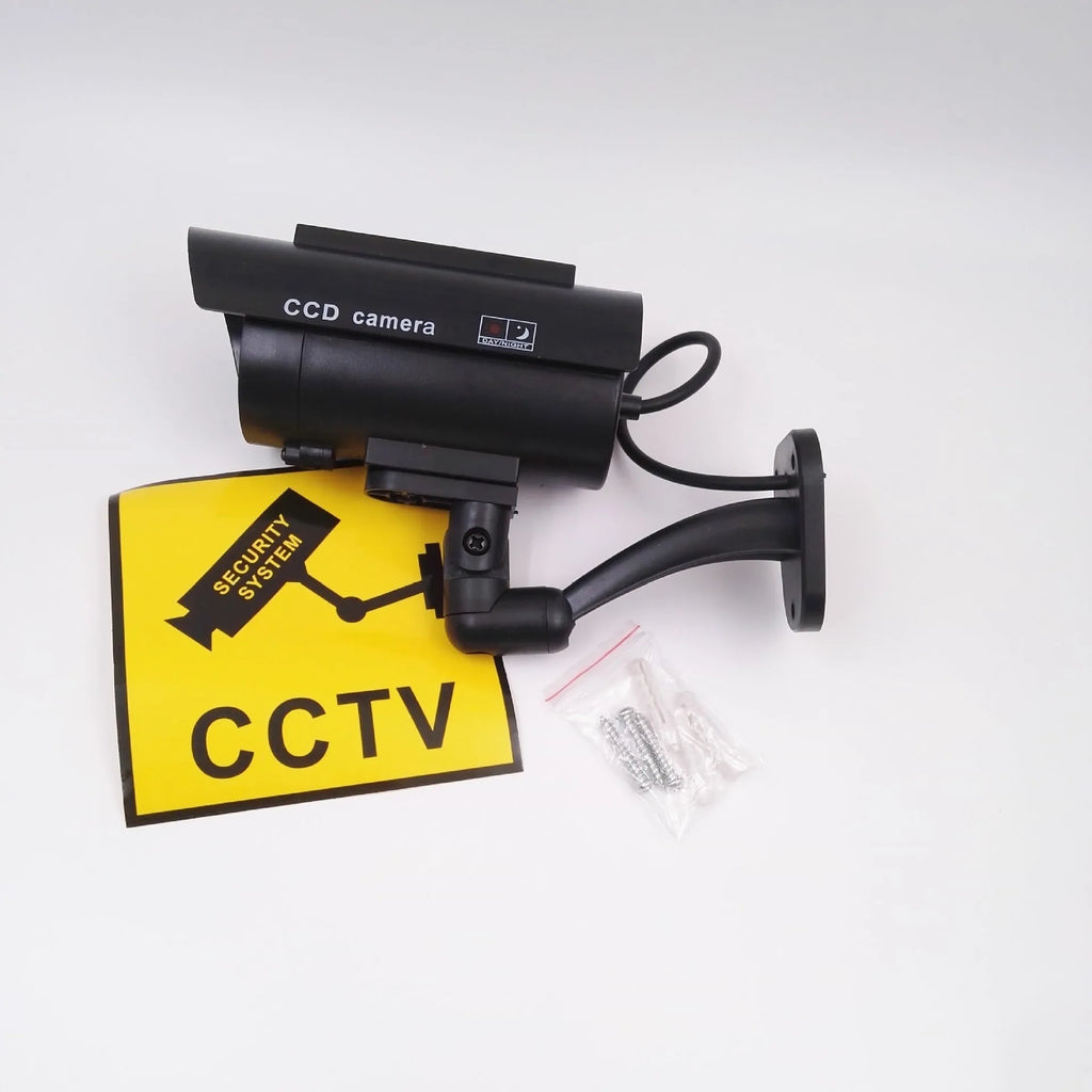 Black solar simulation gun camera security deterrent with flashing red LED light for property protection