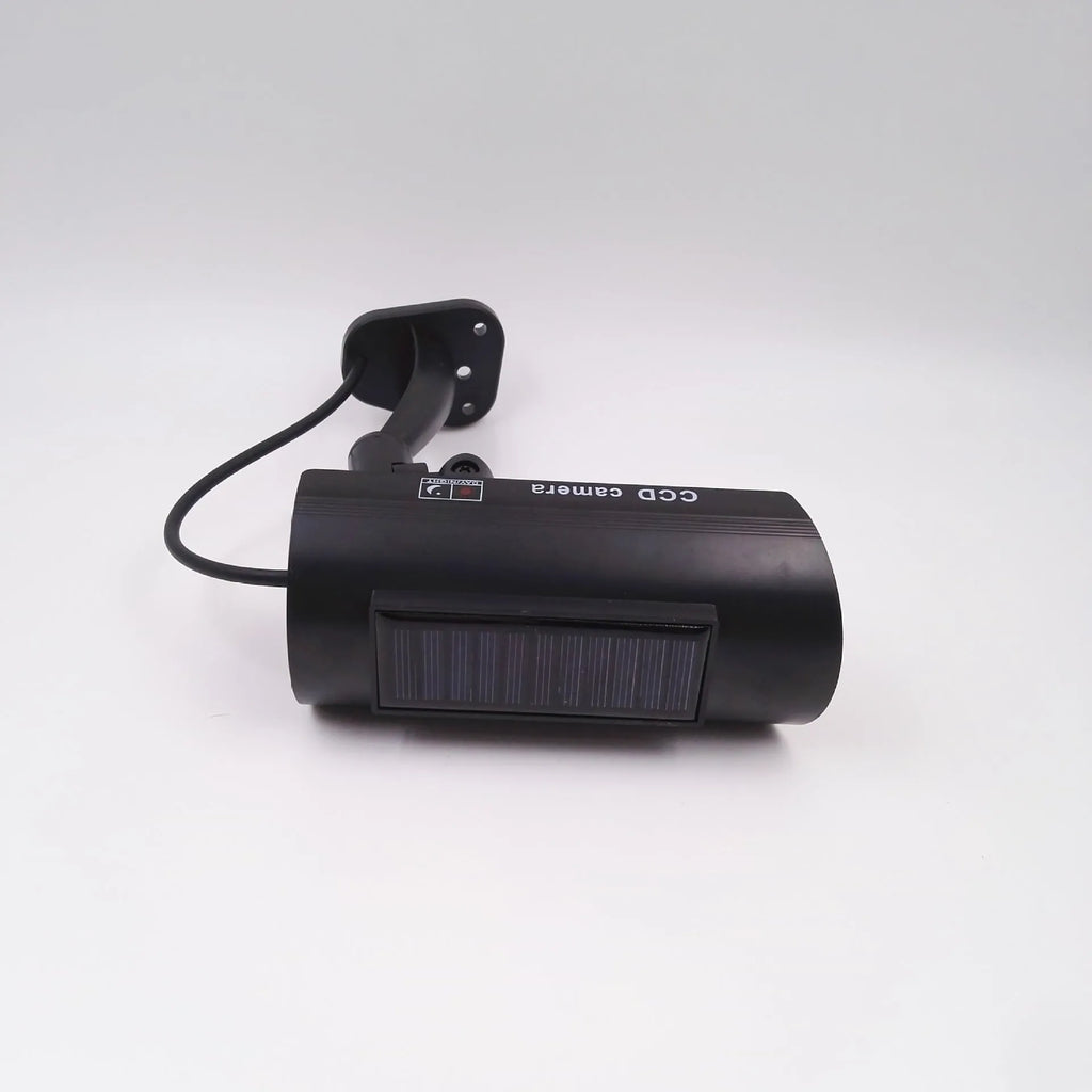 Black solar simulation gun camera security deterrent with flashing red LED light for property protection