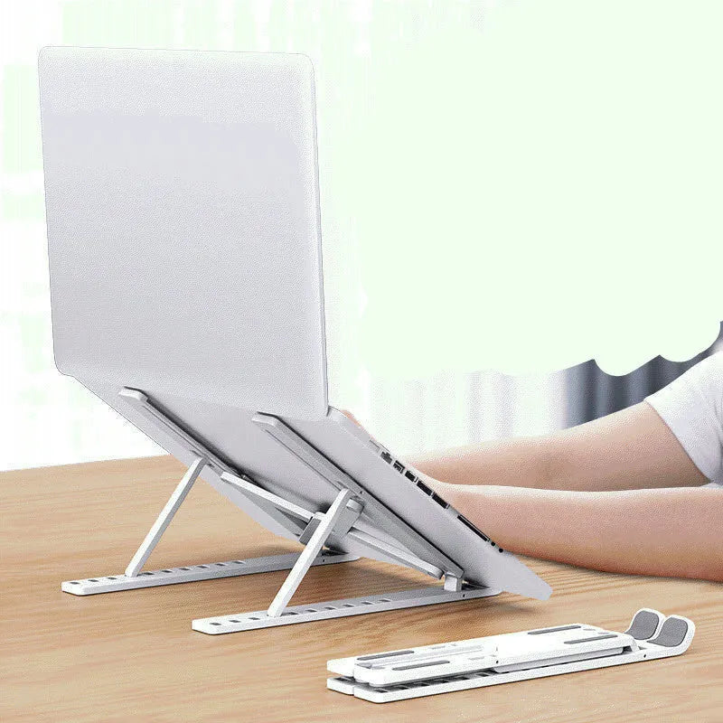 Black foldable laptop stand in an angled position on a wooden desk.