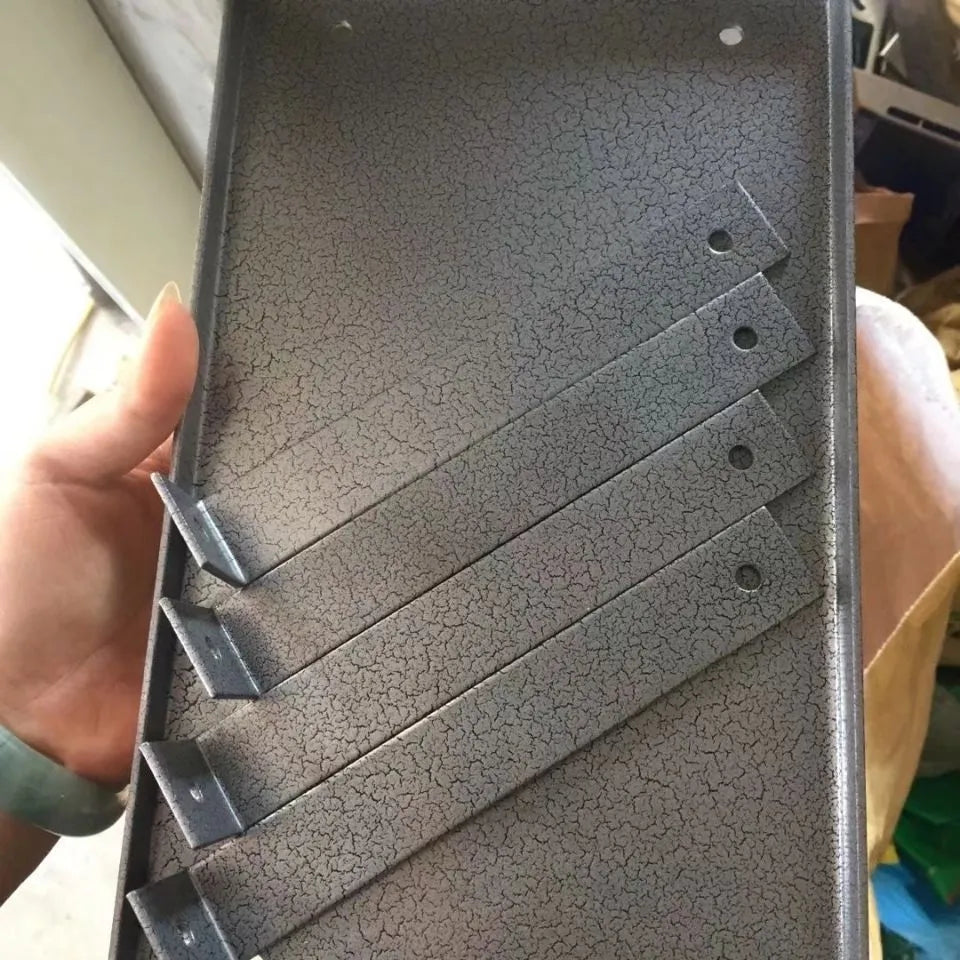 Black iron flip chip bracket for mounting an electric planer upside down, showing dust port.