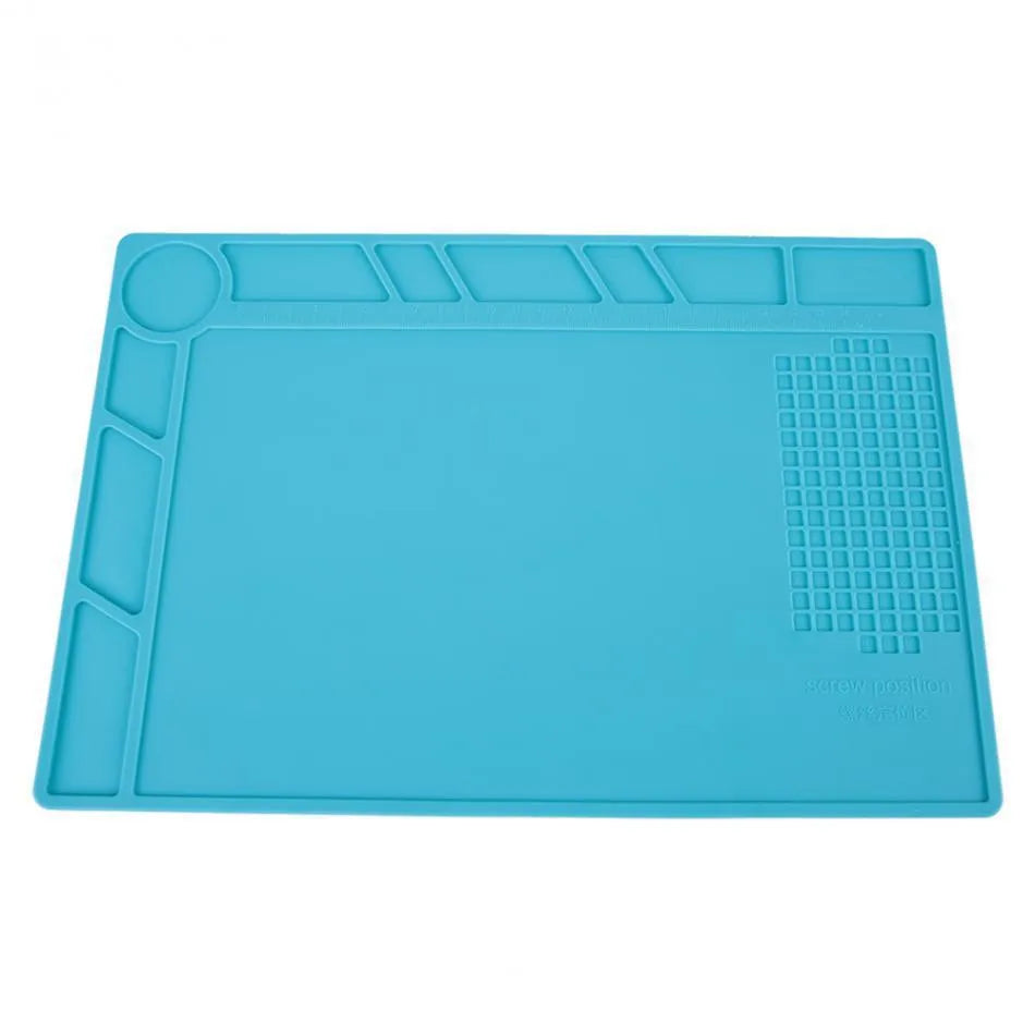Blue silicone anti-skid work desk mat for watch repair and tool organisation.
