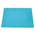 Blue silicone anti-skid work desk mat for watch repair and tool organisation.