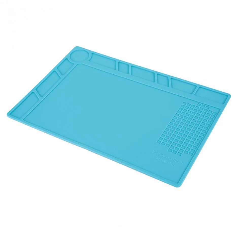Blue silicone anti-skid work desk mat for watch repair and tool organisation.
