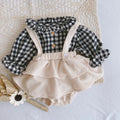 Baby girl wearing a cotton pleated skirt romper with lotus leaf sling design in apricot colour