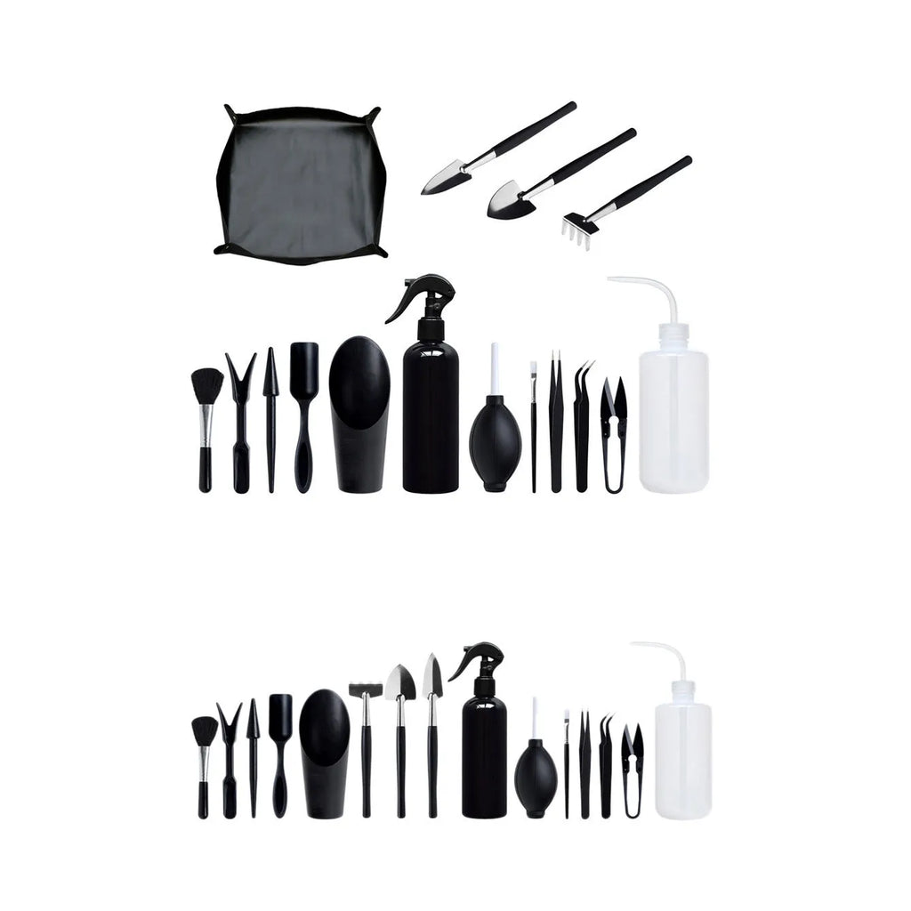Black plastic and metal mini garden tool set for succulents, including small shovel, tweezers, brushes, bottle, and a square cushion.
