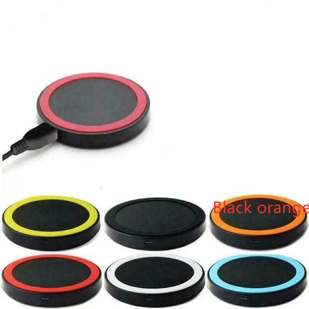 Square Qi wireless charging pad on a table next to a mobile phone.
