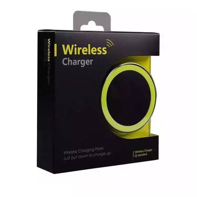 Square Qi wireless charging pad on a table next to a mobile phone.