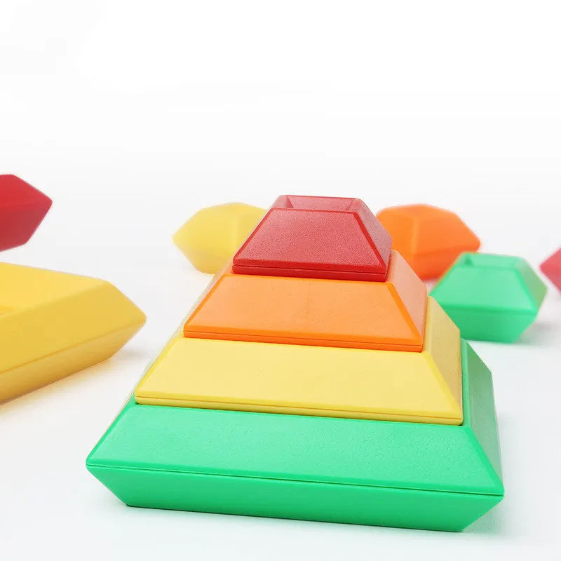 Rainbow coloured tower ring building blocks set for children, with plastic ABS pieces in a barrel.