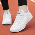 Women's white flat board high-top casual shoes with back lacing and a cross strap.