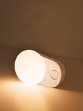 White rechargeable sensor night light with motion detection for bedside or hallway use.
