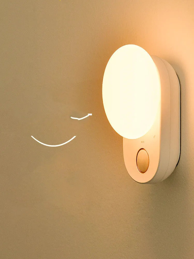 White rechargeable sensor night light with motion detection for bedside or hallway use.
