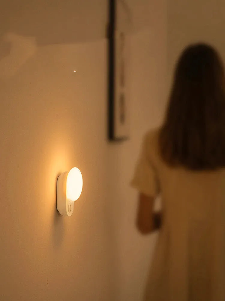 White rechargeable sensor night light with motion detection for bedside or hallway use.