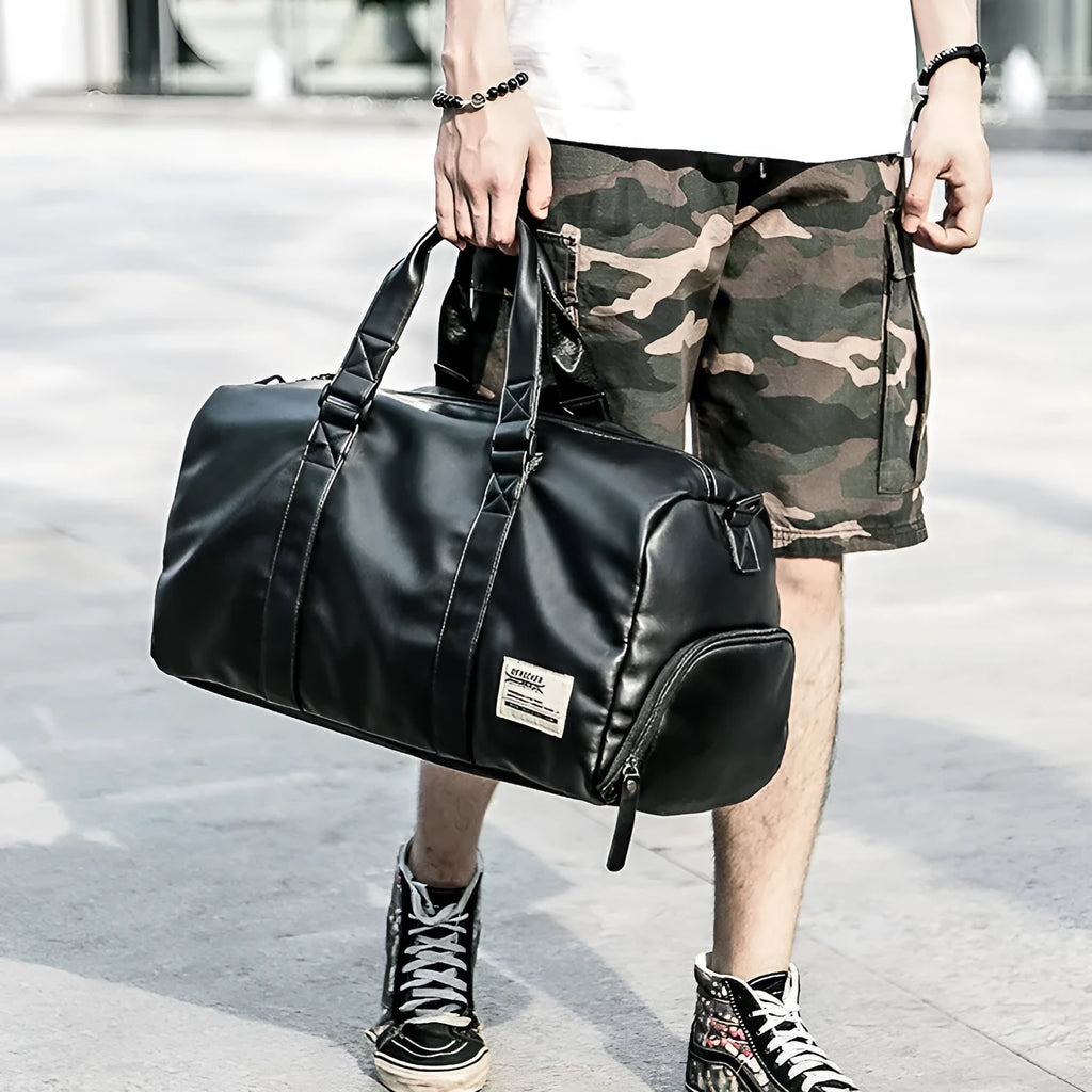Black large capacity waterproof PU leather sports training bag with multiple zipper pockets and a single strap.