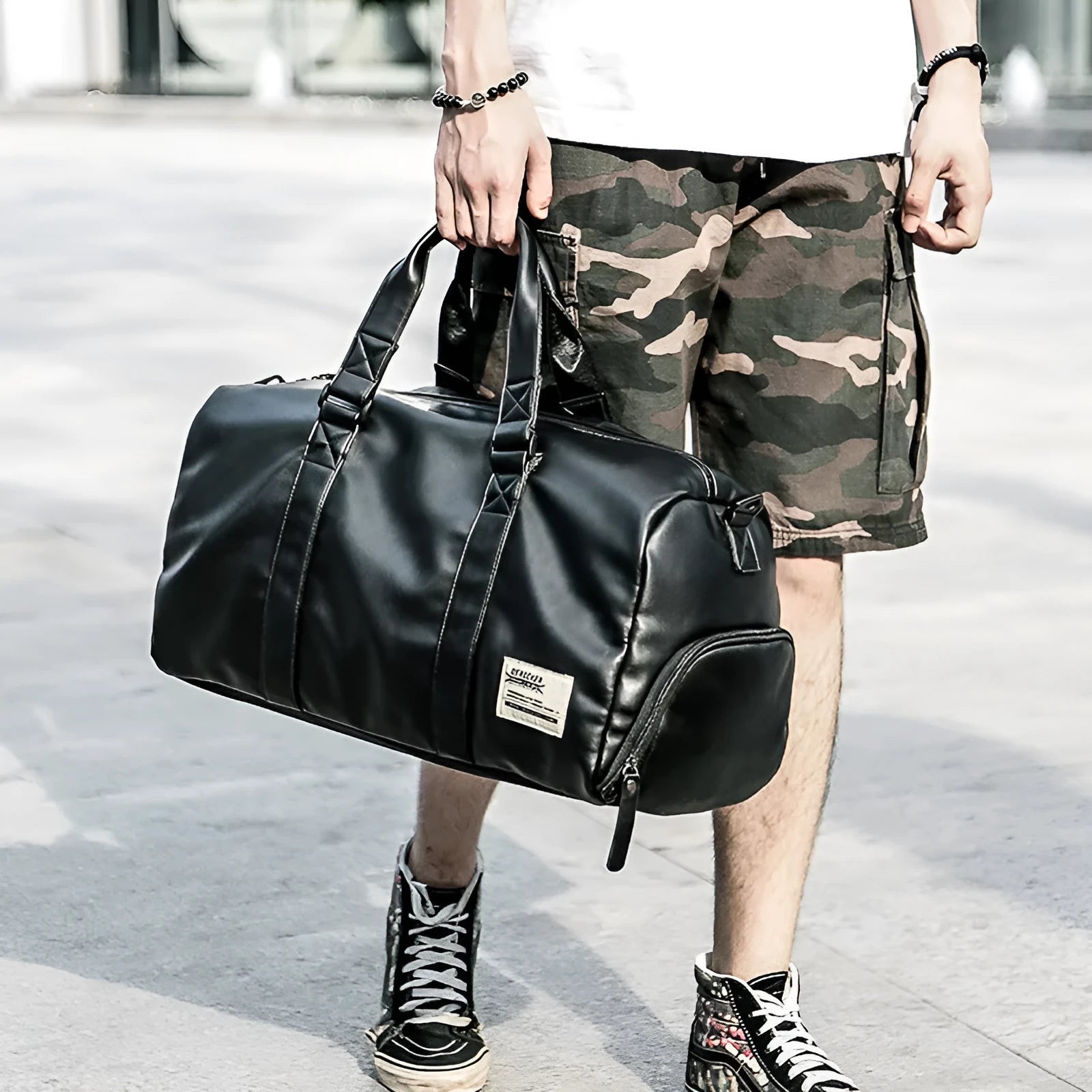 Black large capacity waterproof PU leather sports training bag with multiple zipper pockets and a single strap.