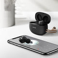 Pebble Series wireless Bluetooth earbuds in charging case, shown in black, white, or dark green.