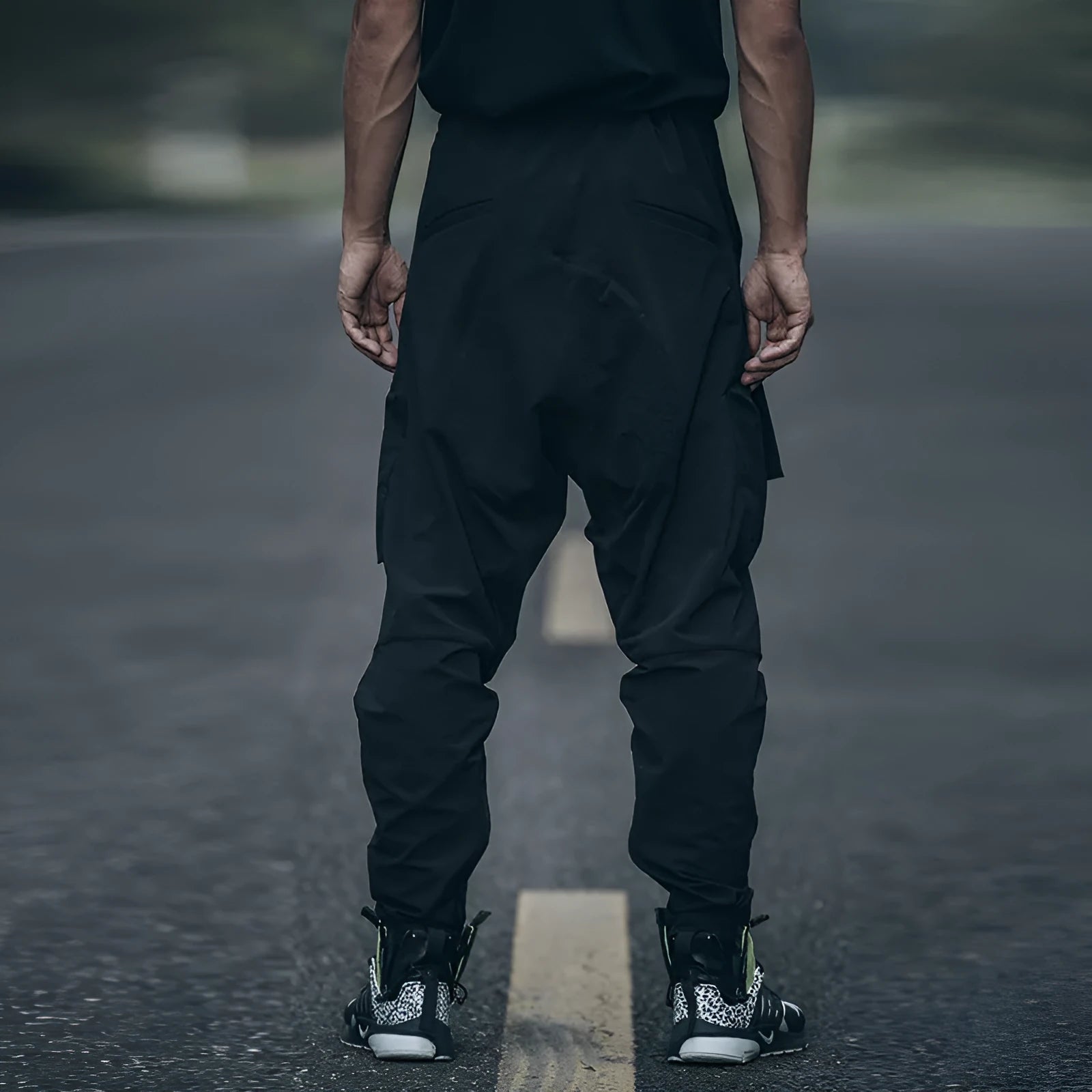 New men's black casual pants with loose fit and pockets on a model