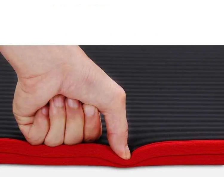 10mm thick black NBR yoga mat measuring 60 by 181 centimetres on a floor