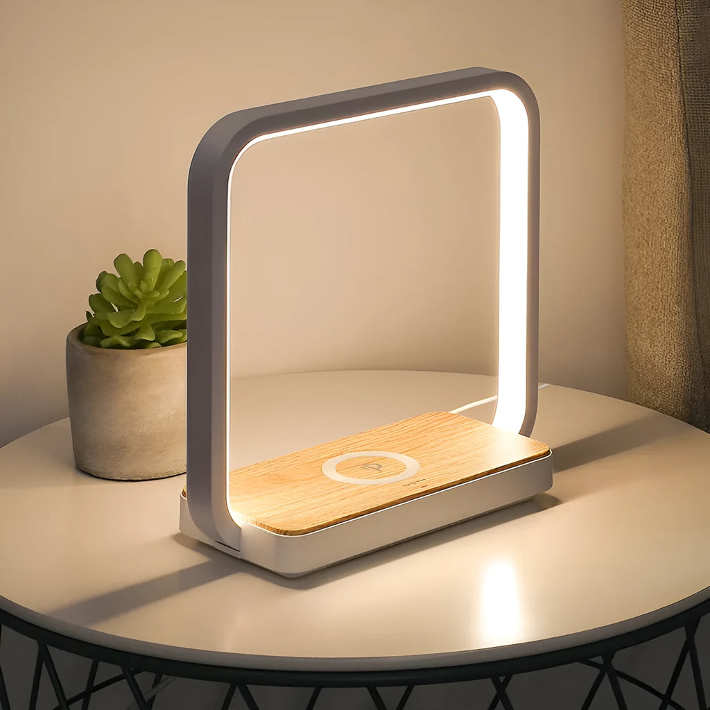 Modern white smart bedside lamp with voice control and USB cable on a wooden nightstand.