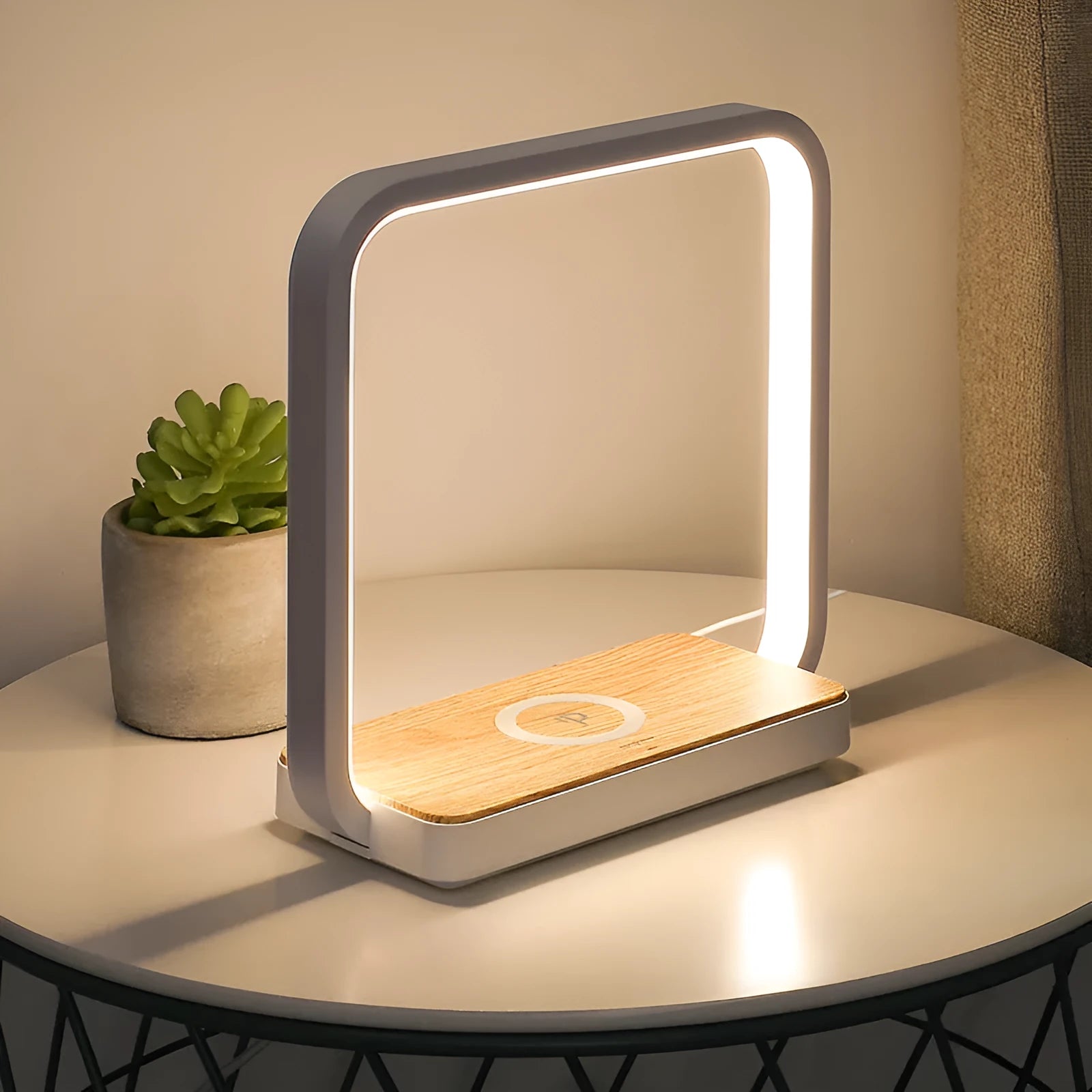 Modern white smart bedside lamp with voice control and USB cable on a wooden nightstand.