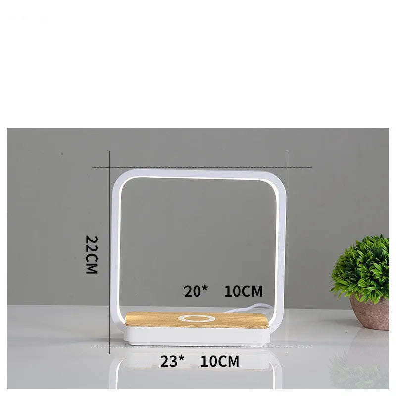 Modern white smart bedside lamp with voice control and USB cable on a wooden nightstand.