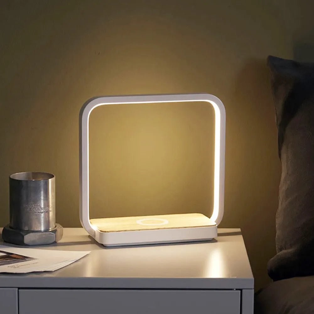 Modern white smart bedside lamp with voice control and USB cable on a wooden nightstand.