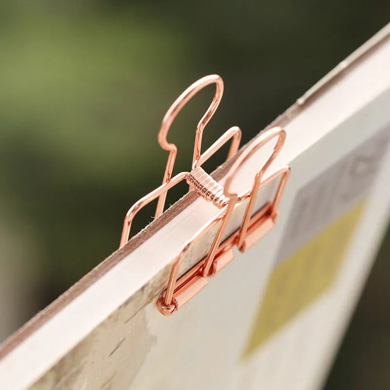 Rose gold metal binder set showing small and large folders with metal clasps for test papers and tickets