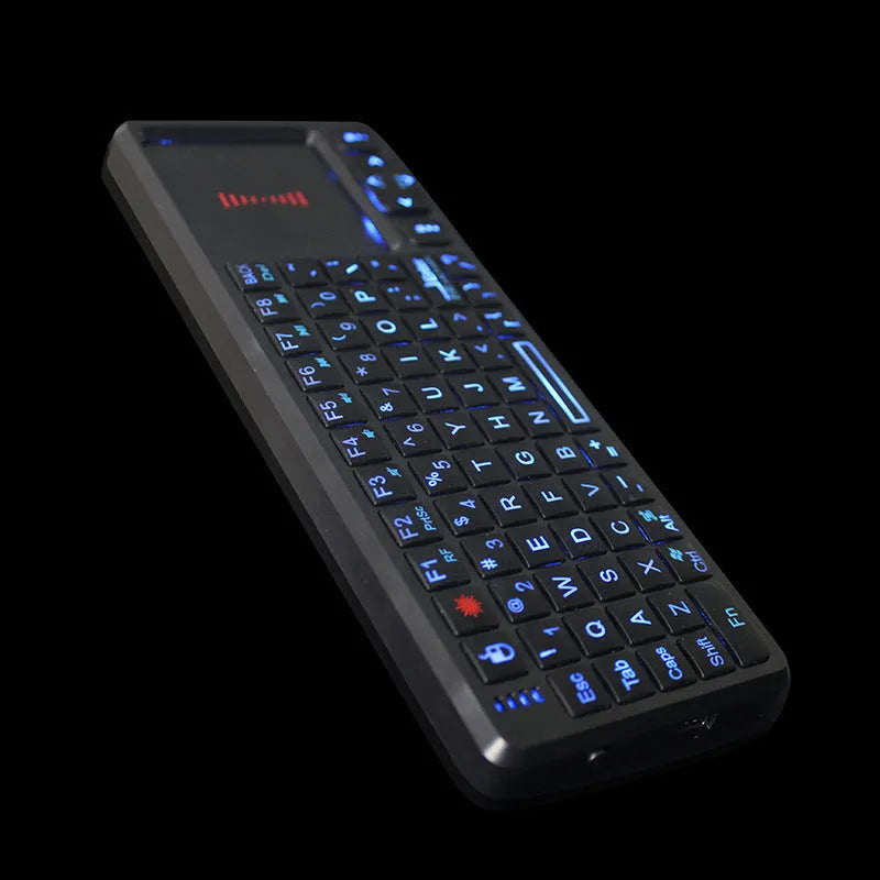 Black wireless mini keyboard with touch screen touchpad and integrated laser pointer for presentations.
