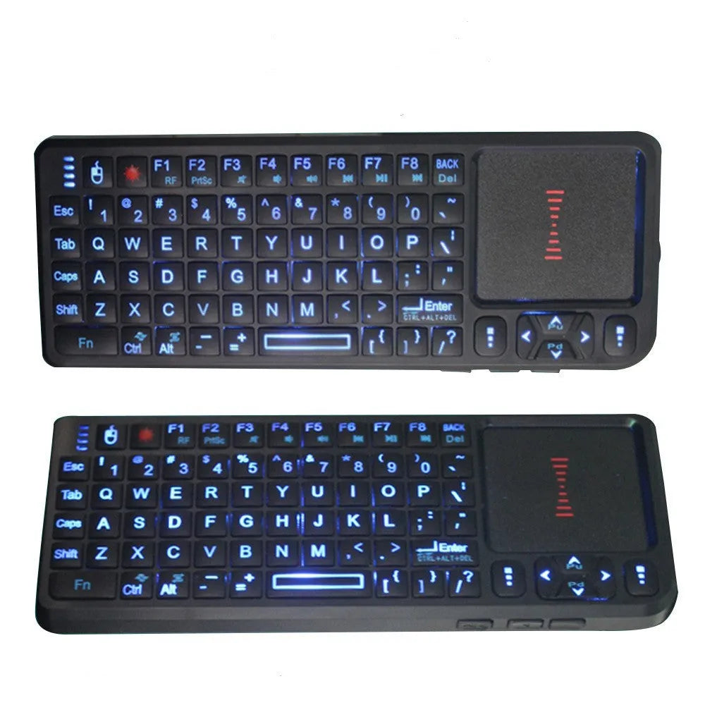 Black wireless mini keyboard with touch screen and matching optical mouse on a desk.