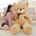 Large plush teddy bear doll with ribbon details in light brown, pink, white, khaki or dark brown colours