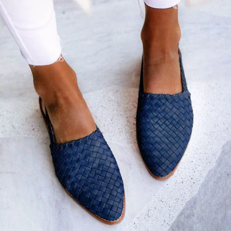 A pair of pointed-toe baotou flat sandals with an adjustable buckle strap, shown in a dark brown colour.