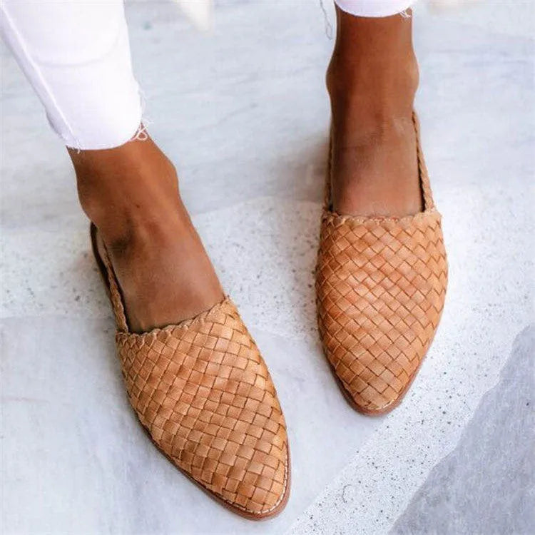 A pair of pointed-toe baotou flat sandals with an adjustable buckle strap, shown in a dark brown colour.