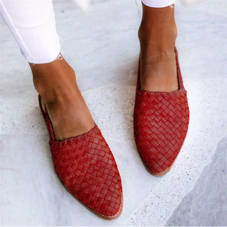 A pair of pointed-toe baotou flat sandals with an adjustable buckle strap, shown in a dark brown colour.