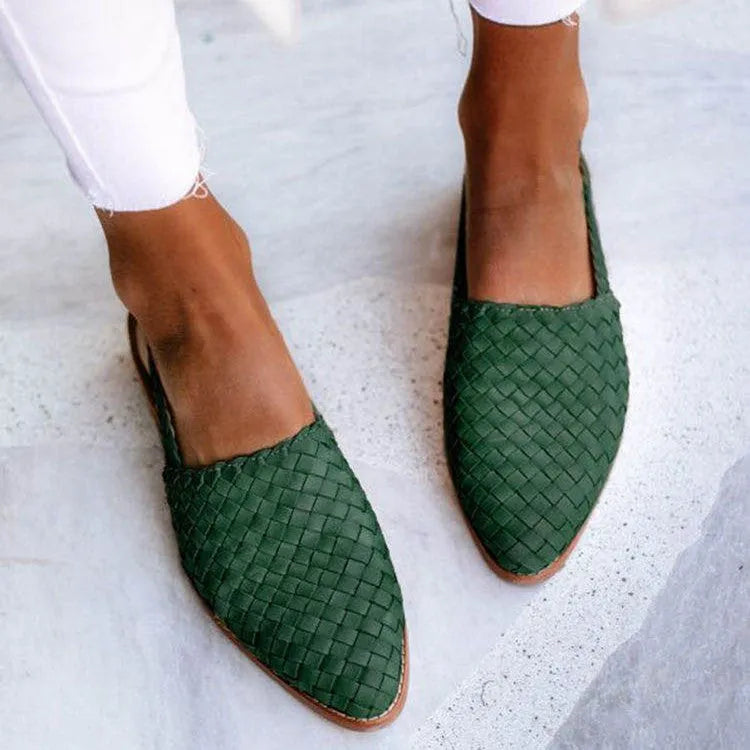 A pair of pointed-toe baotou flat sandals with an adjustable buckle strap, shown in a dark brown colour.