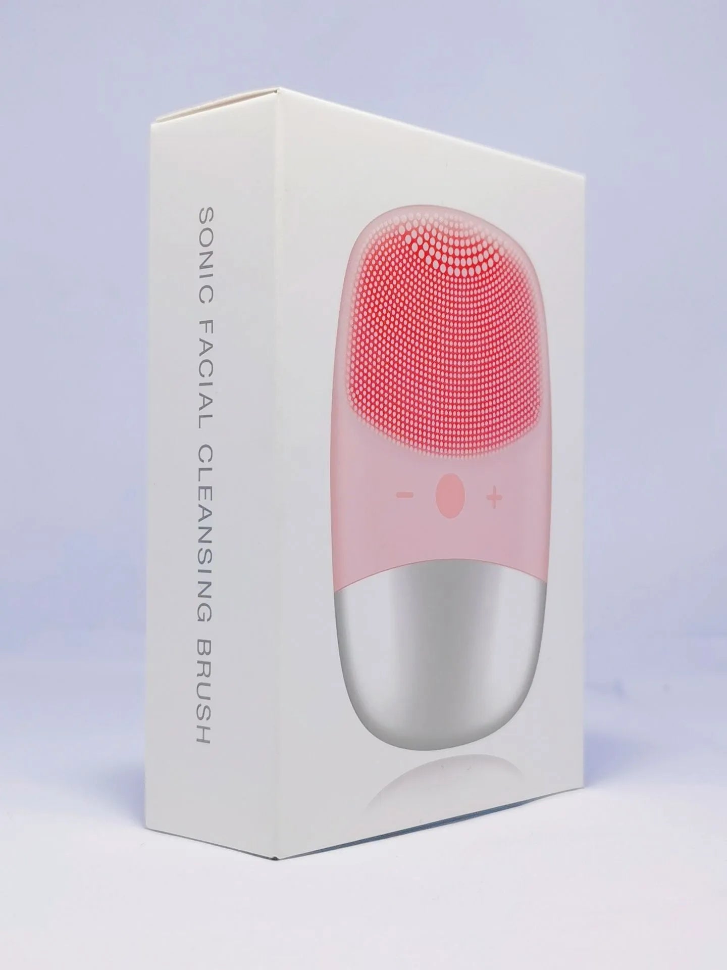 Mini pink silicone electric face cleansing brush with sonic vibration and USB charging on a white background