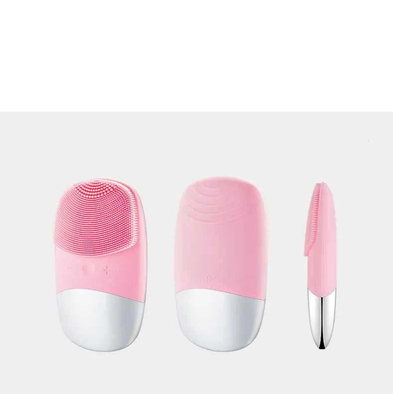 Mini pink silicone electric face cleansing brush with sonic vibration and USB charging on a white background