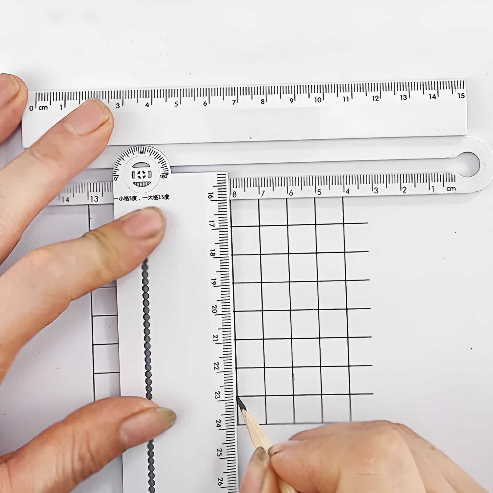 White plastic multi-function ruler with straight edge and angle measurement markings at 30cm length