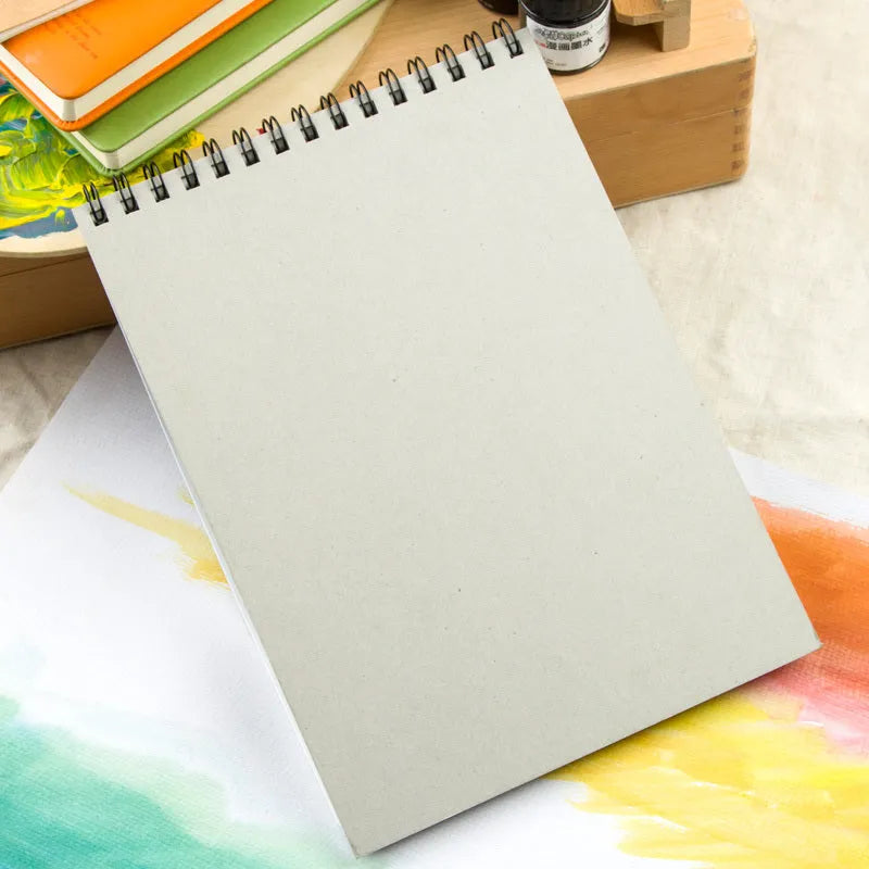 Green cover spiral-bound water-soluble sketchbook for coloured pencil painting, shown in 8K and 16K sizes.